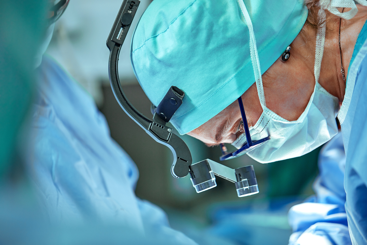 Female surgeon in operation room with reflection in glasses,