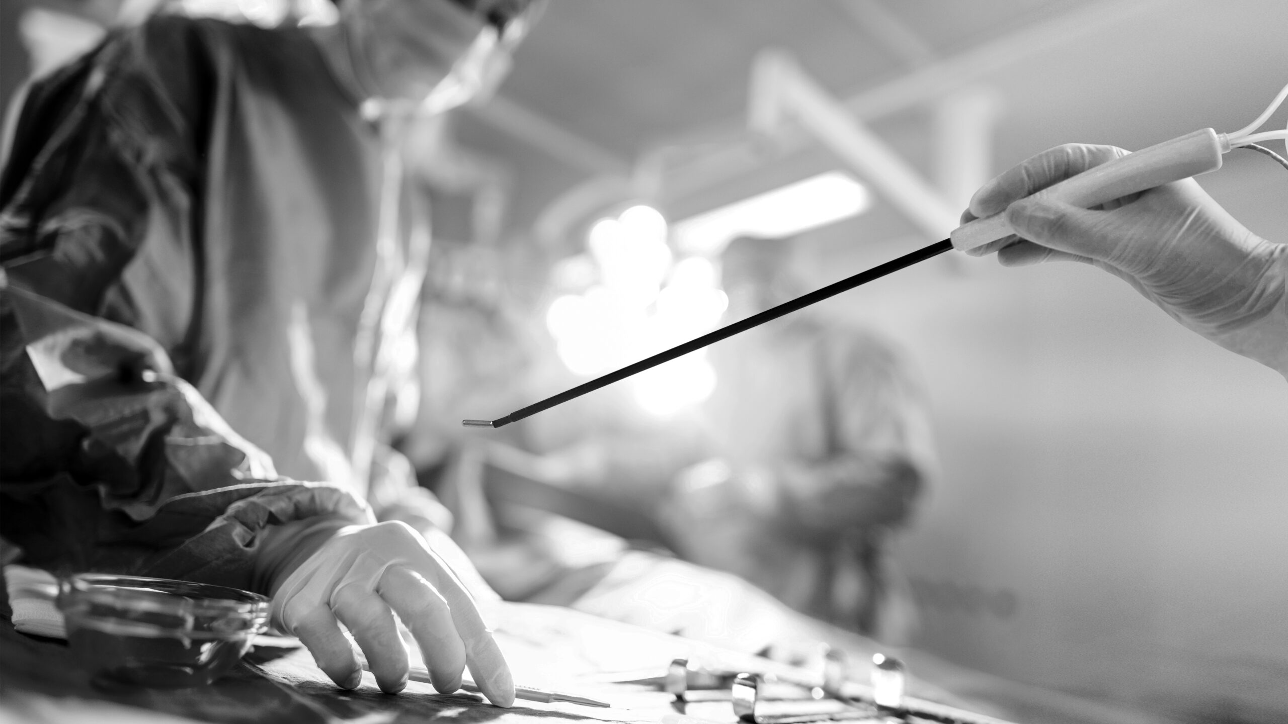 Close-up Shot in Operating Room of Surgical Table with Instruments, Assistant Picks up Instruments for Surgeons During Operation. Surgery in Progress. Professional Medical Doctors Performing Surgery.